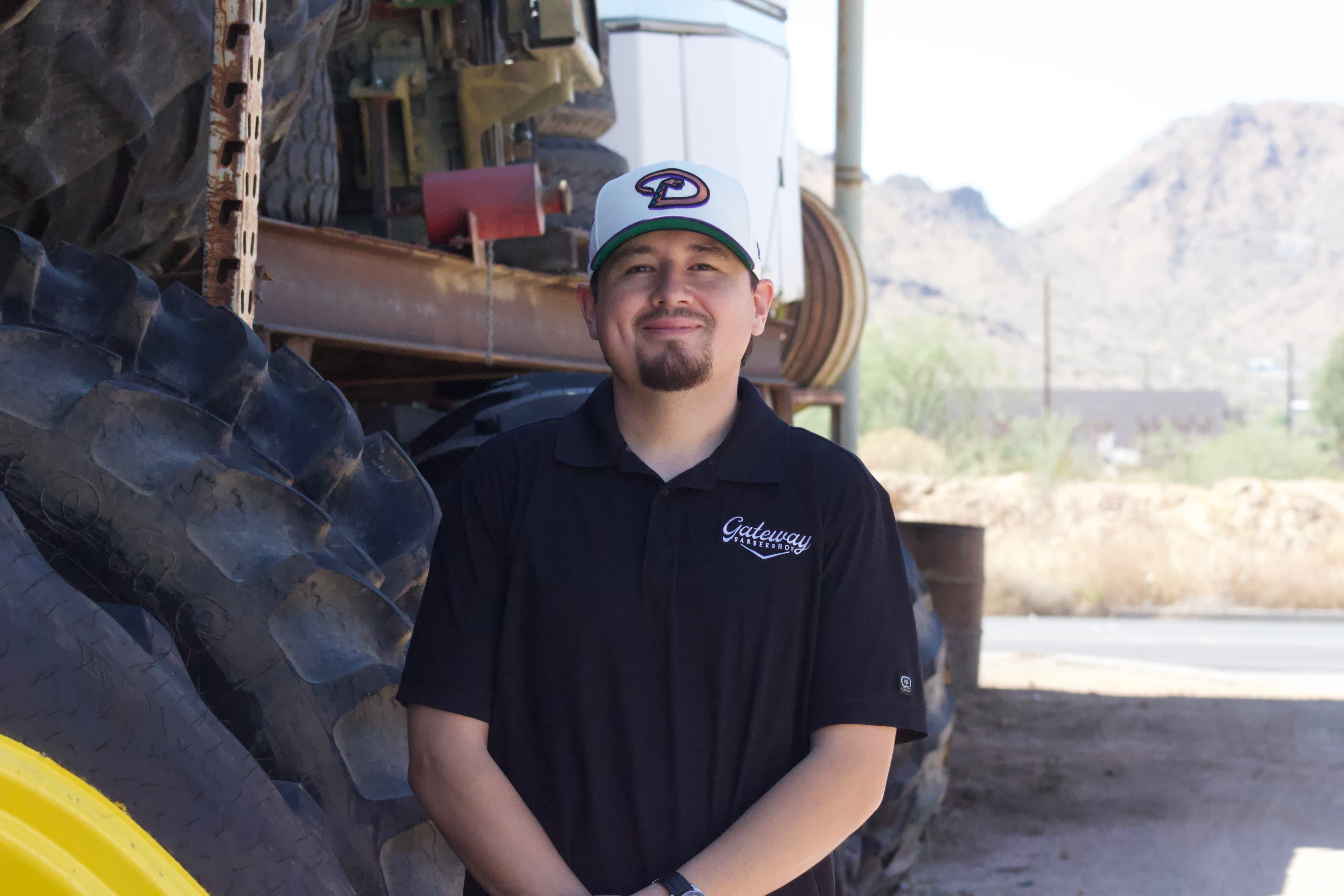 Gerardo, known as Panda, standing near farm equipment in Arizona